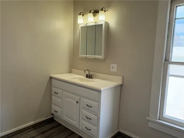 a bathroom with a double vanity sink and a mirror