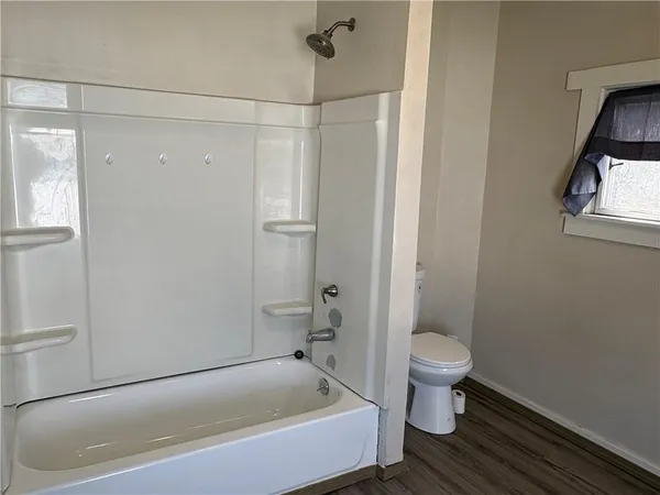 a bathroom with a bathtub and toilet
