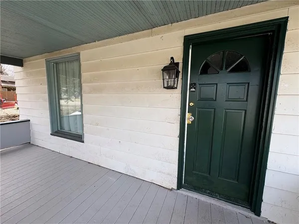 a view of front door and deck of the house