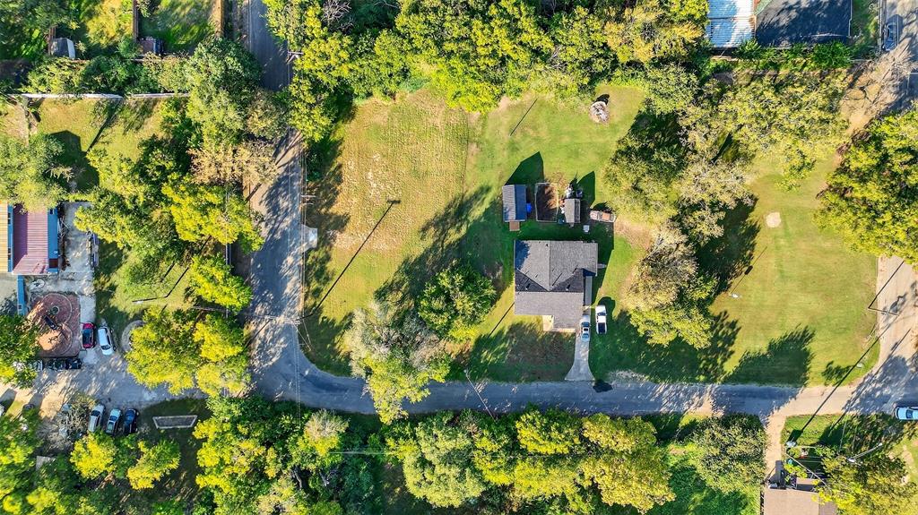 an aerial view of residential house with swimming pool and lawn chairs
