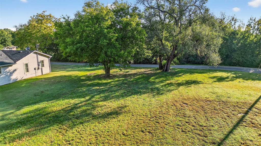2018 South Inwood Street Sherman, TX 75090 - Photo 11 of 22 a swimming pool with trees in the background