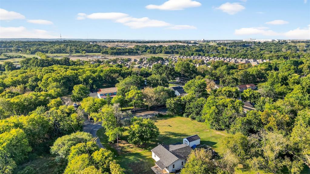 2018 South Inwood Street Sherman, TX 75090 - Photo 18 of 22 a view of a city with lush green forest