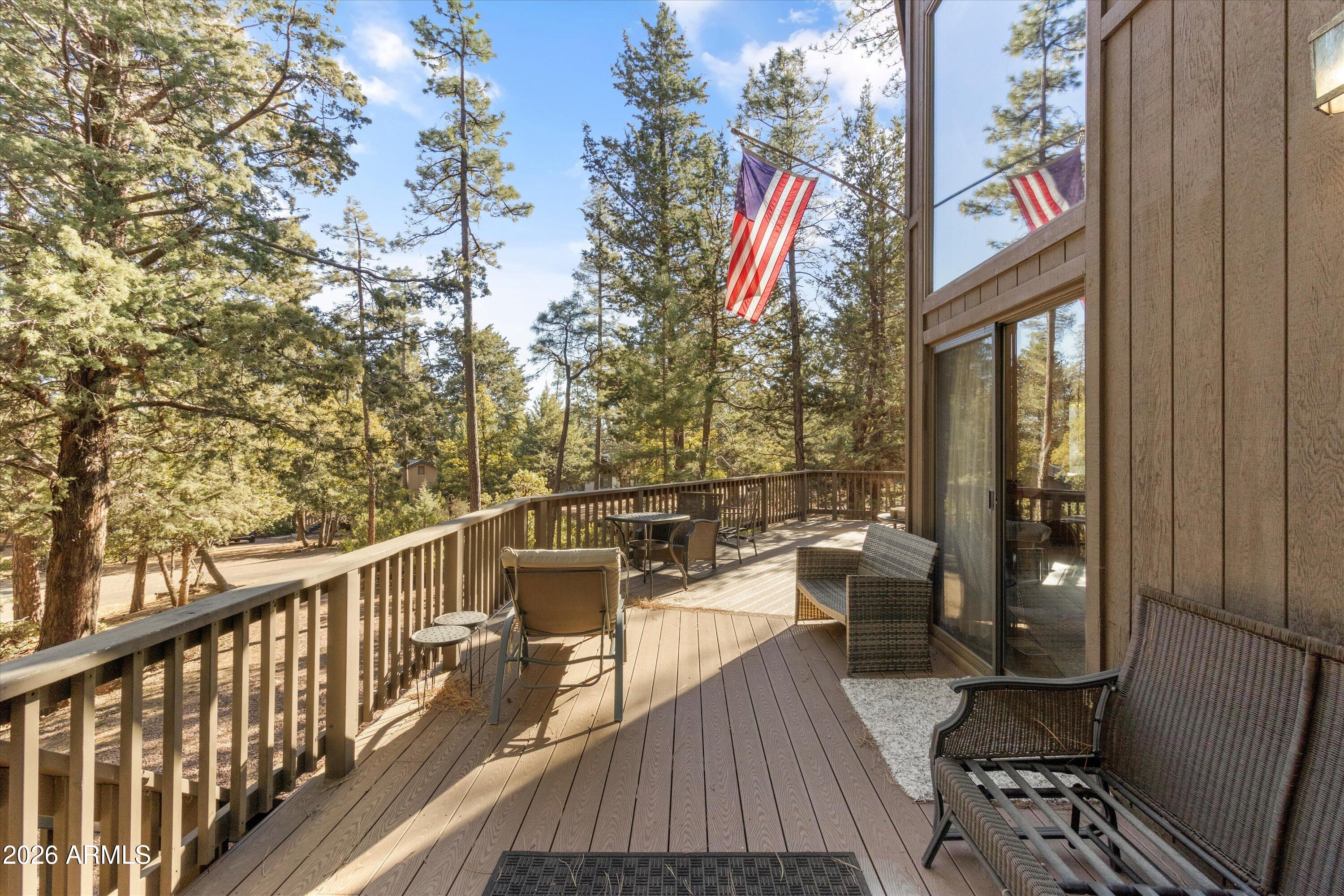 6181 Pinon Loop Pine, AZ 85544 - Photo 26 of 36 a view of a balcony with chairs and wooden floor