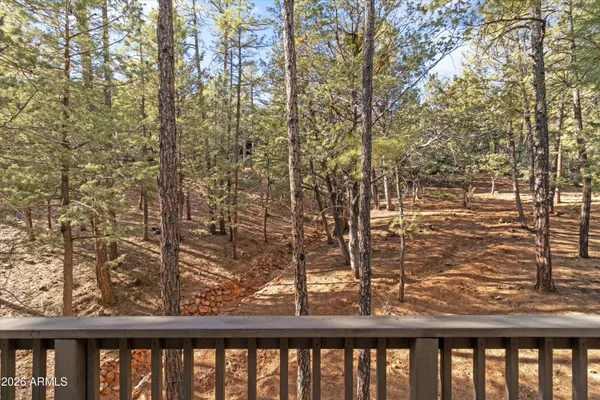 a view of balcony with wooden floor and fence