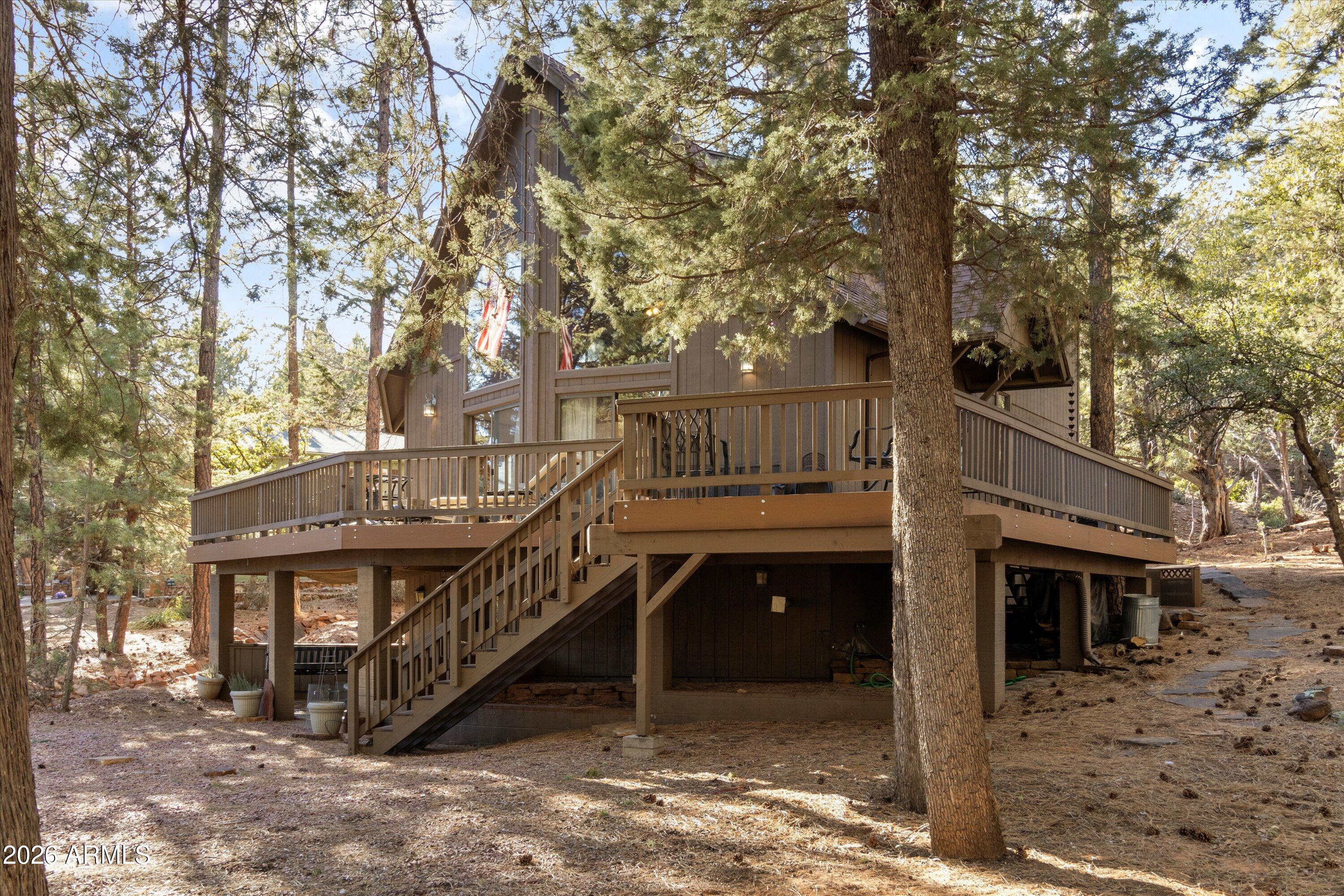 6181 Pinon Loop Pine, AZ 85544 - Photo 33 of 36 a view of house with outdoor space and trees