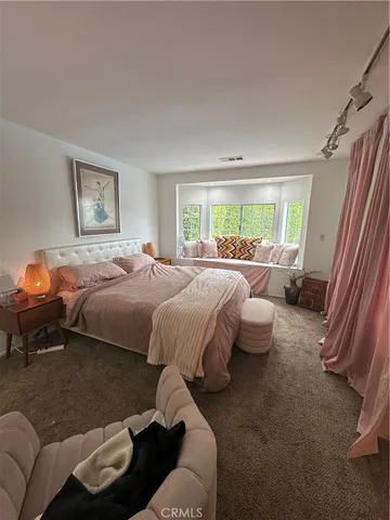 a bedroom with a bed and window
