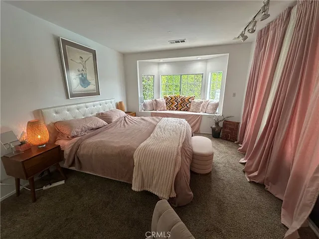 a bed room with a bed and a window