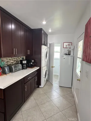 a kitchen with stainless steel appliances granite countertop a refrigerator a stove and a sink