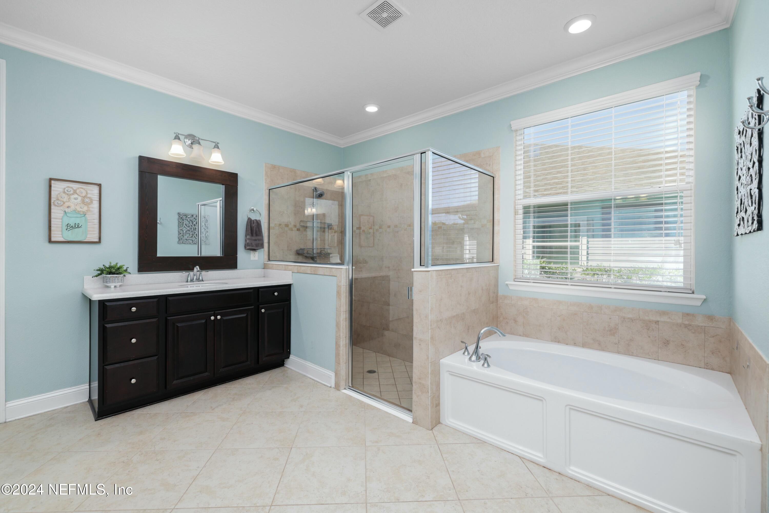 404 St Kitts Loop St. Augustine, FL 32092 - Photo 20 of 68 a spacious bathroom with a tub sink and mirror