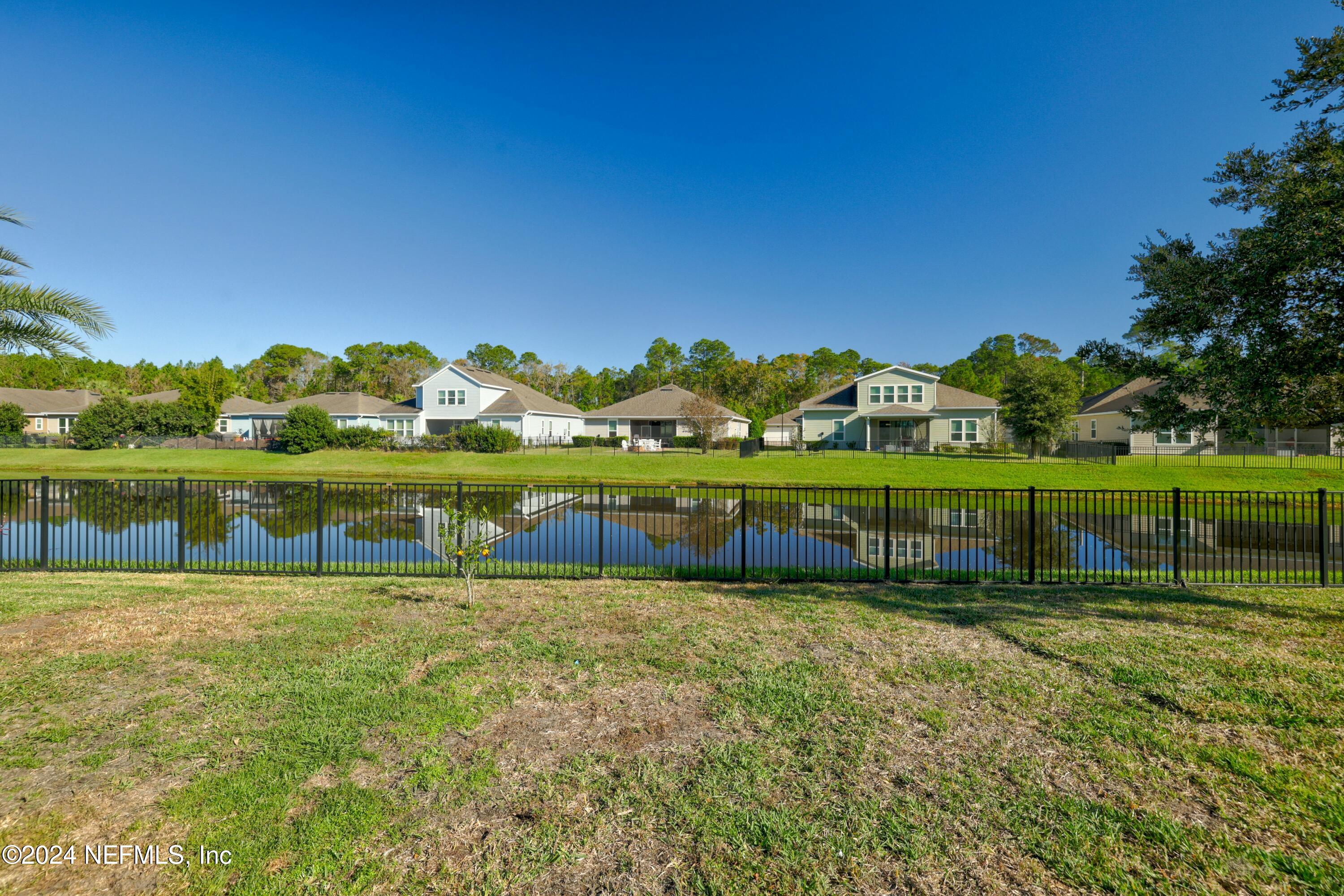 404 St Kitts Loop St. Augustine, FL 32092 - Photo 24 of 68 a view of a lake with houses in the background