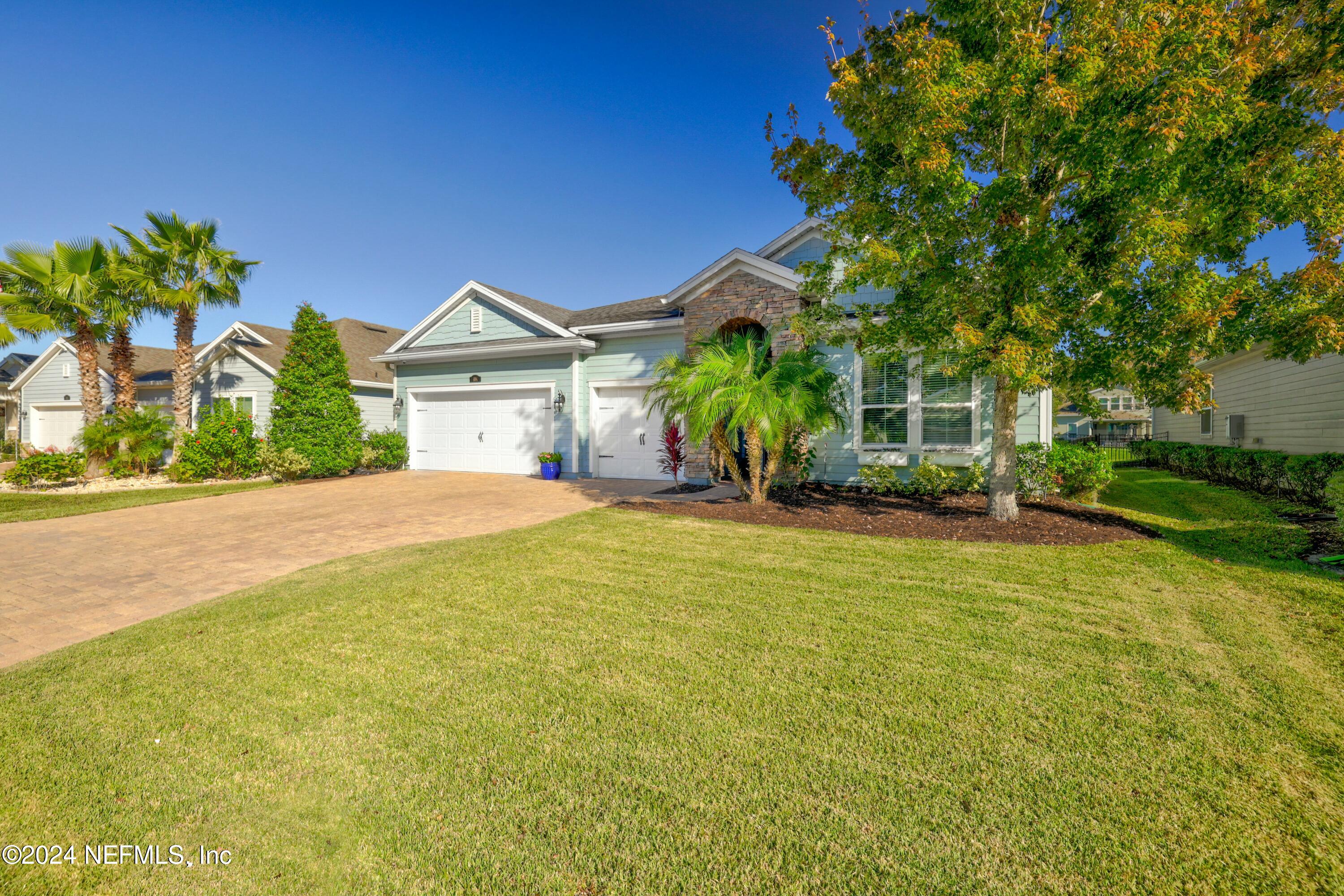 404 St Kitts Loop St. Augustine, FL 32092 - Photo 26 of 68 a front view of a house with a yard and potted plants