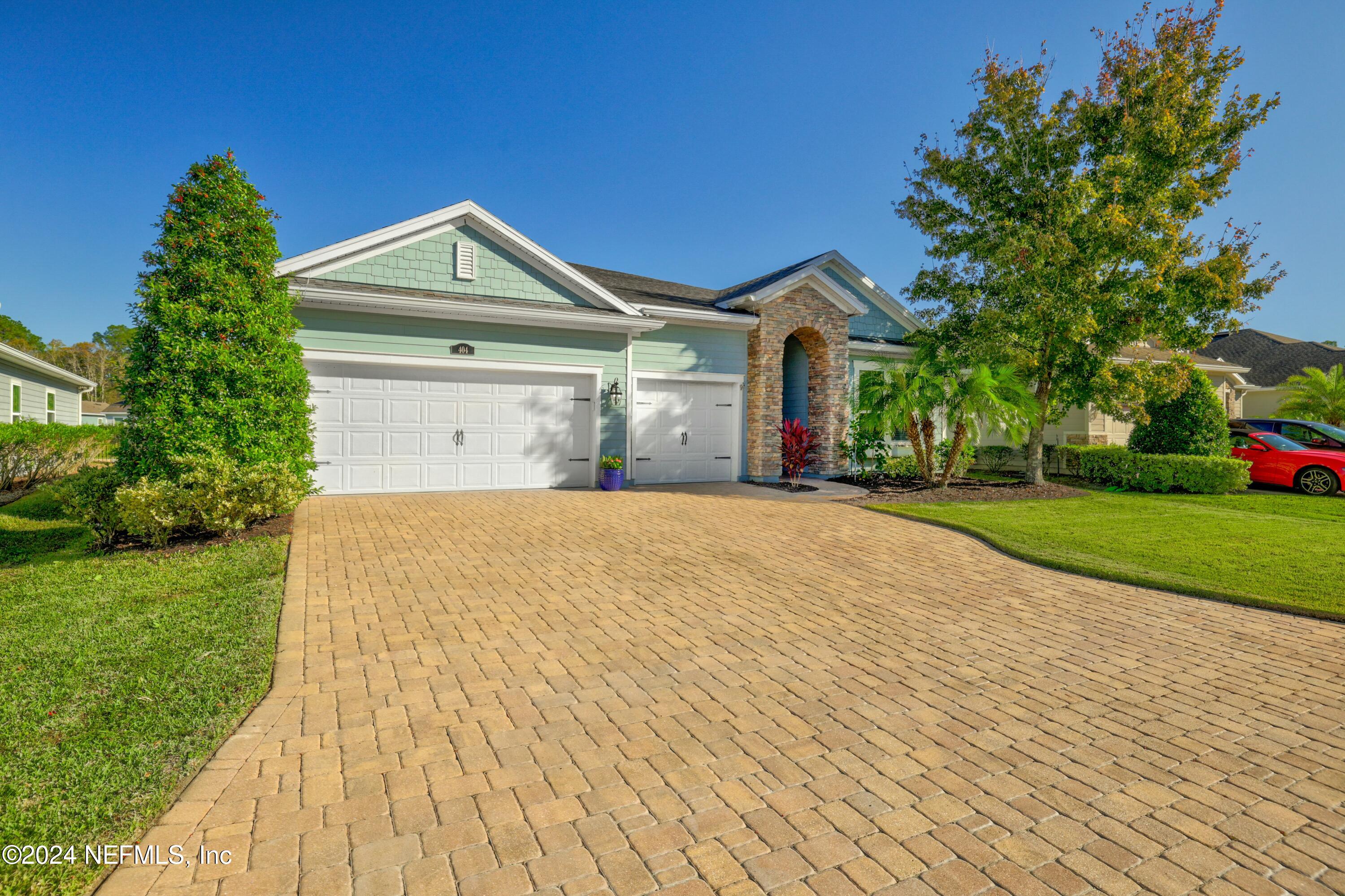 404 St Kitts Loop St. Augustine, FL 32092 - Photo 32 of 68 a front view of a house with a yard and garage
