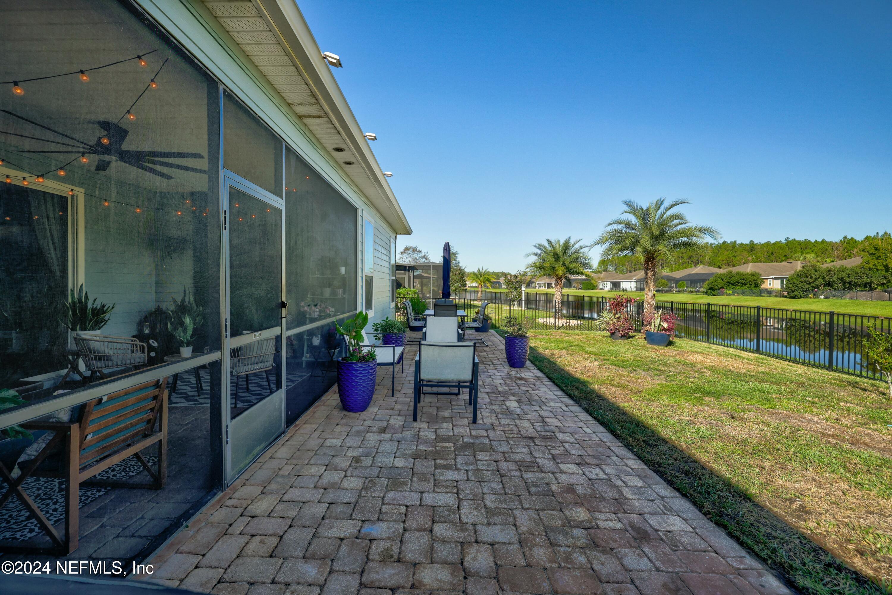 404 St Kitts Loop St. Augustine, FL 32092 - Photo 34 of 68 a view of a patio with a dining table and chairs with wooden floor