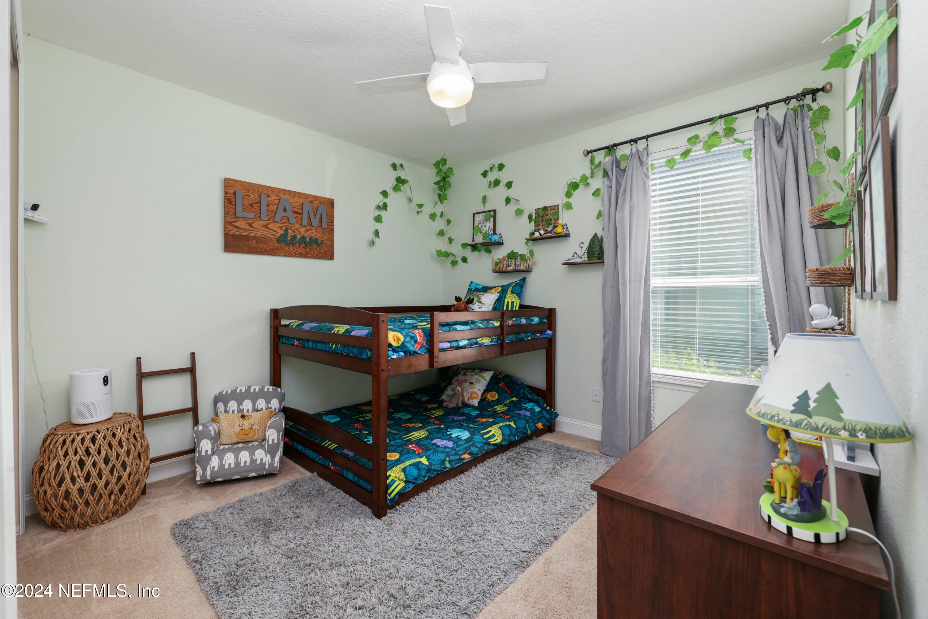 404 St Kitts Loop St. Augustine, FL 32092 - Photo 36 of 68 a bedroom with furniture and a window