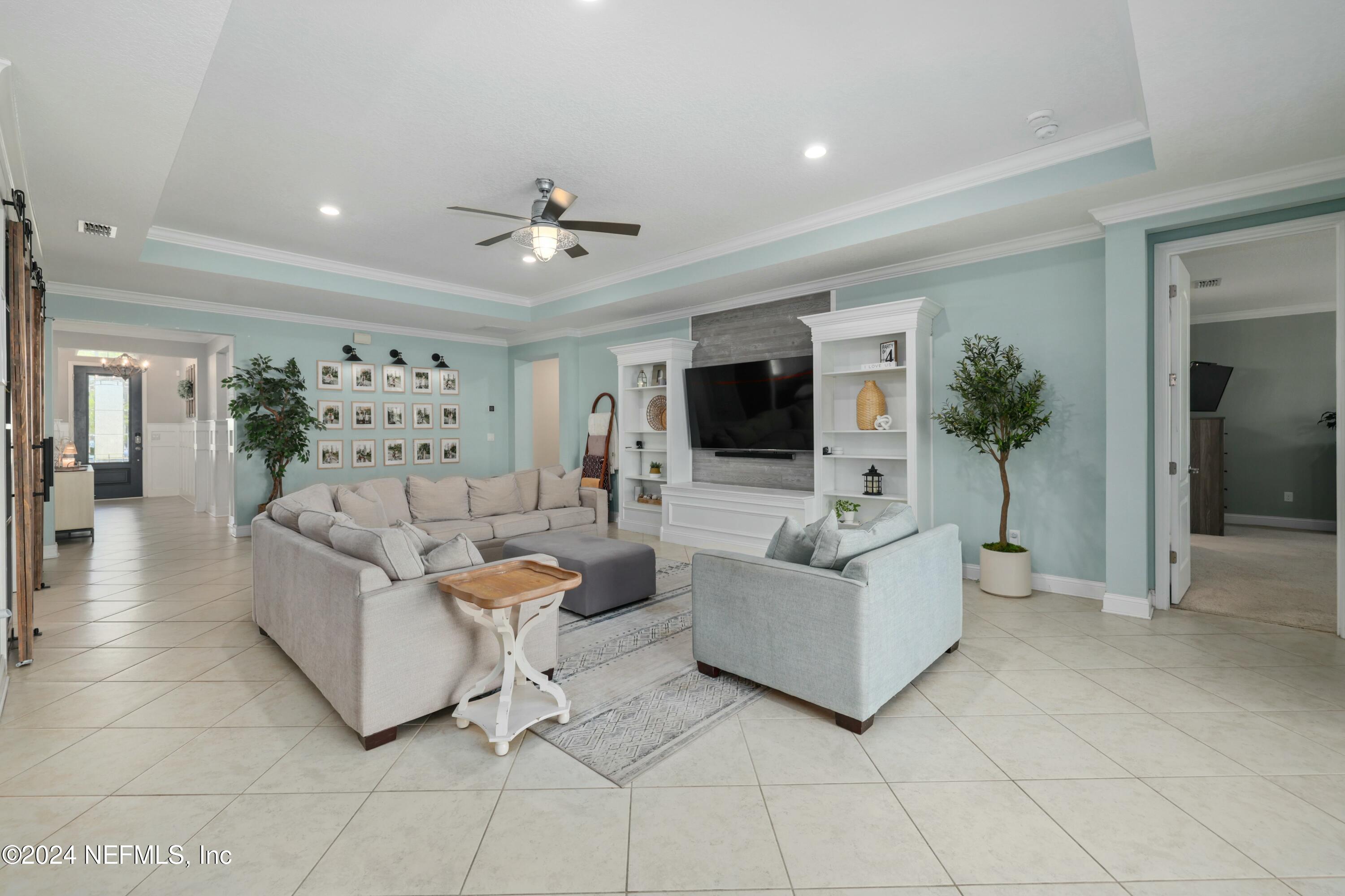 404 St Kitts Loop St. Augustine, FL 32092 - Photo 5 of 68 a living room with furniture and a flat screen tv
