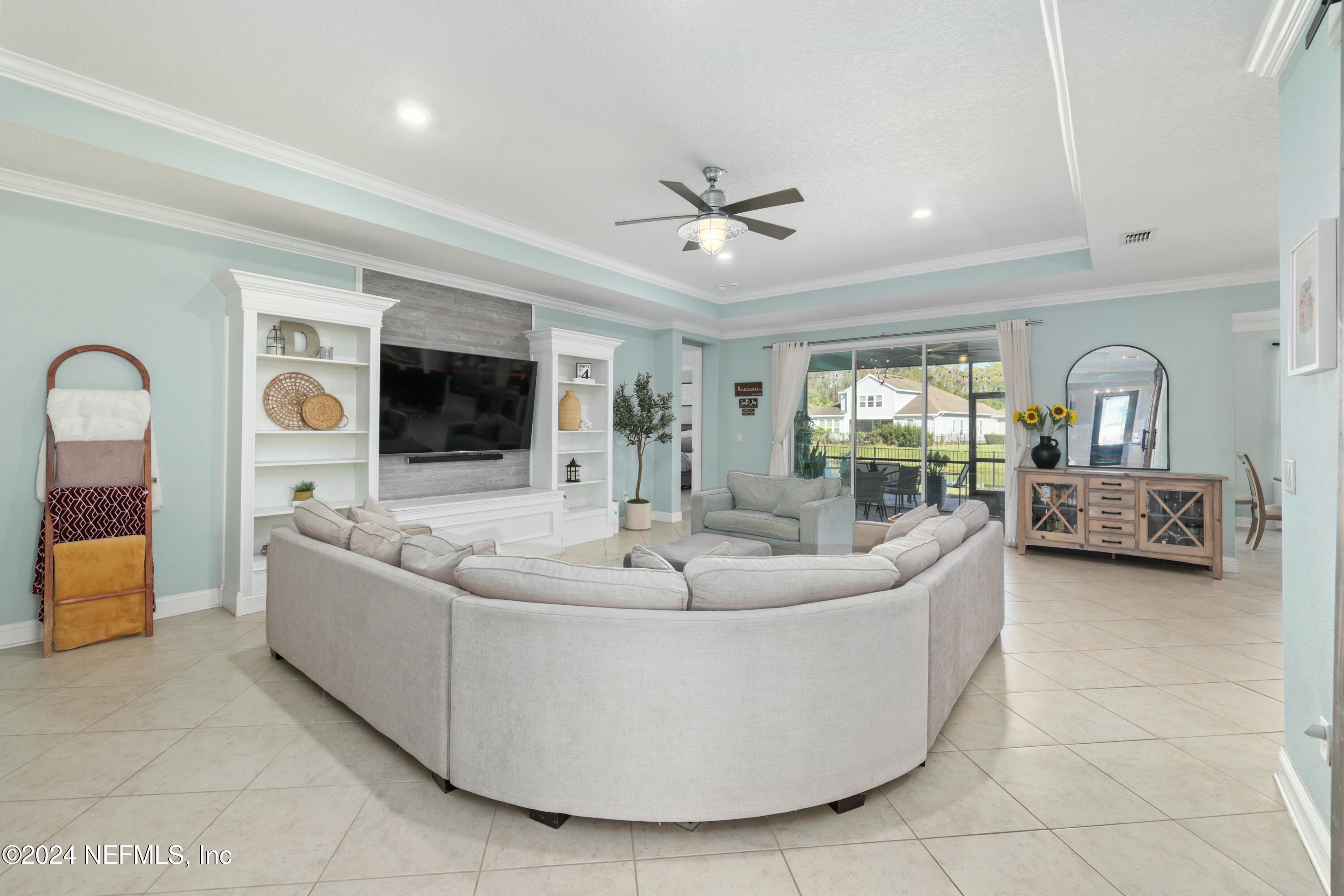 404 St Kitts Loop St. Augustine, FL 32092 - Photo 54 of 68 a living room with couches and a flat screen tv