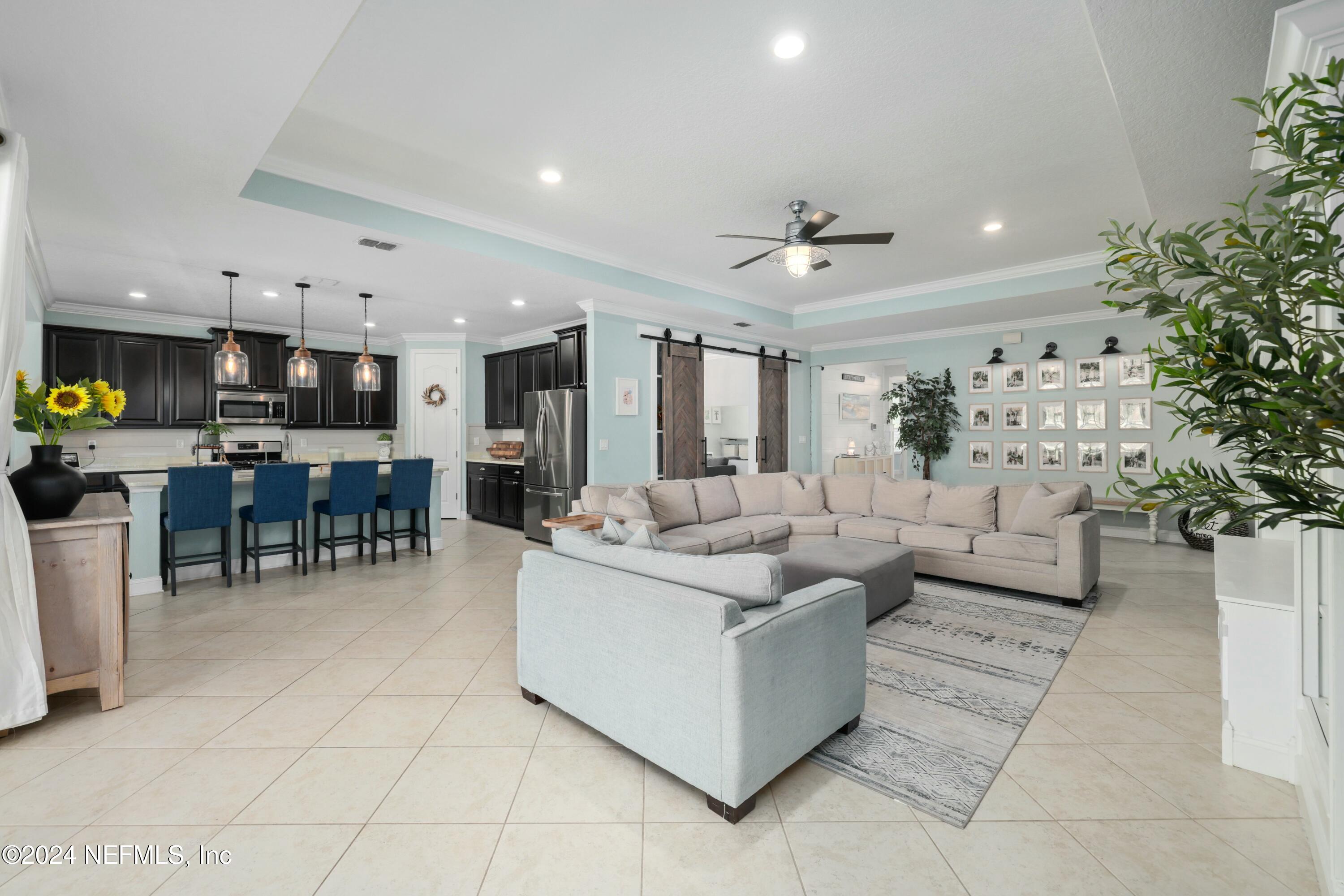 404 St Kitts Loop St. Augustine, FL 32092 - Photo 56 of 68 a living room with furniture and a dining table with kitchen view