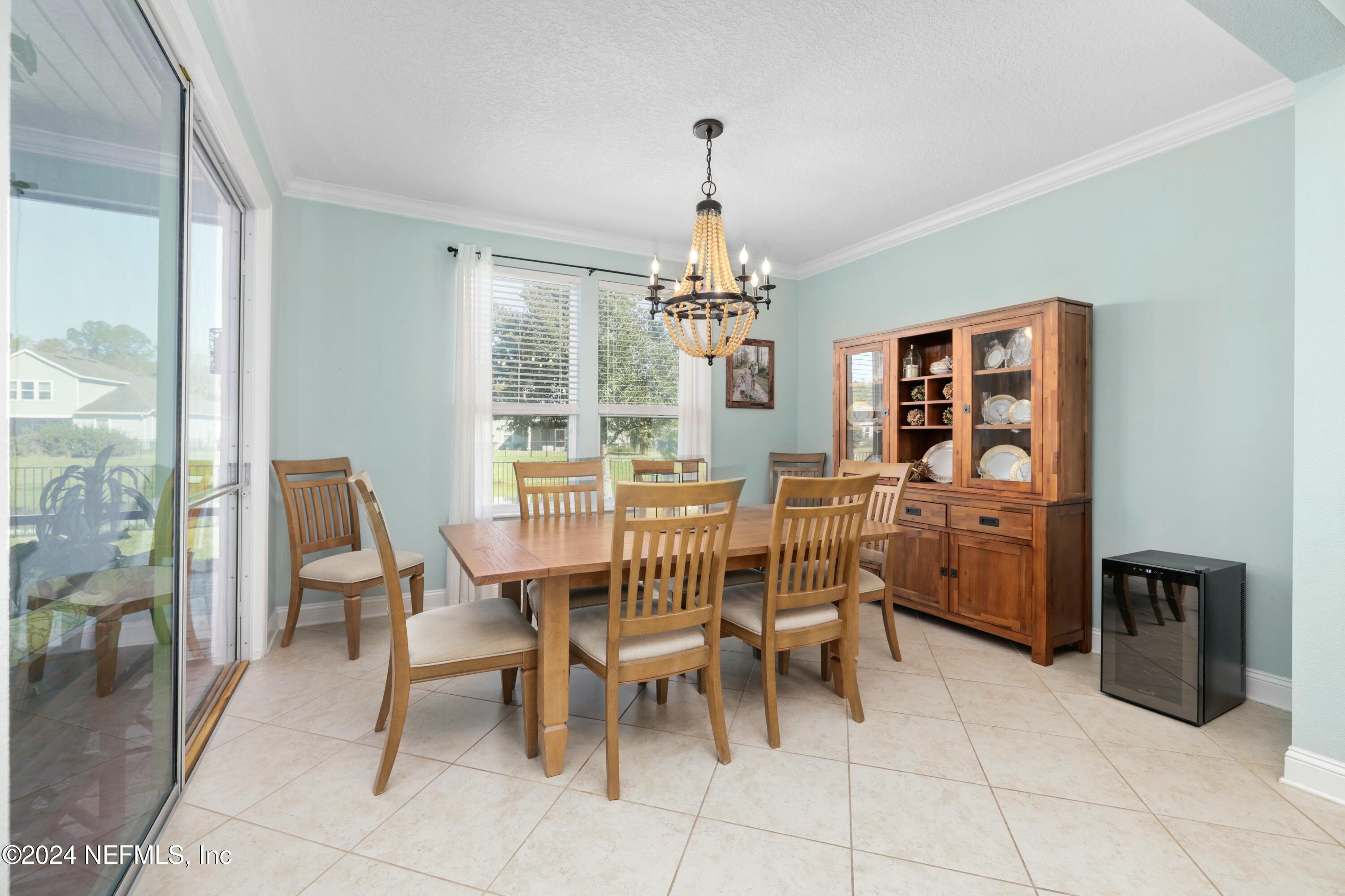 404 St Kitts Loop St. Augustine, FL 32092 - Photo 57 of 68 a dining room with furniture and chandelier