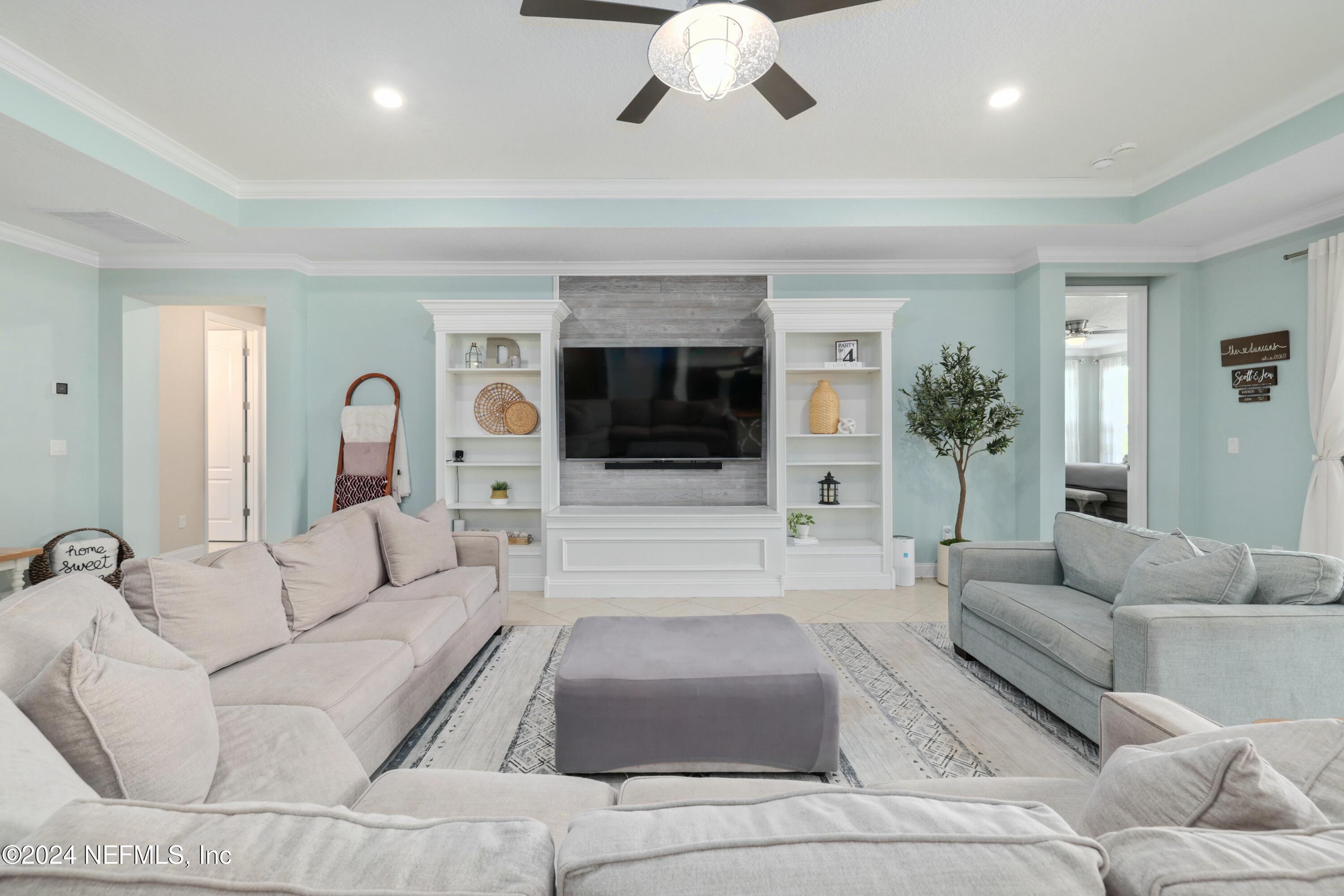 404 St Kitts Loop St. Augustine, FL 32092 - Photo 6 of 68 a living room with furniture and a flat screen tv
