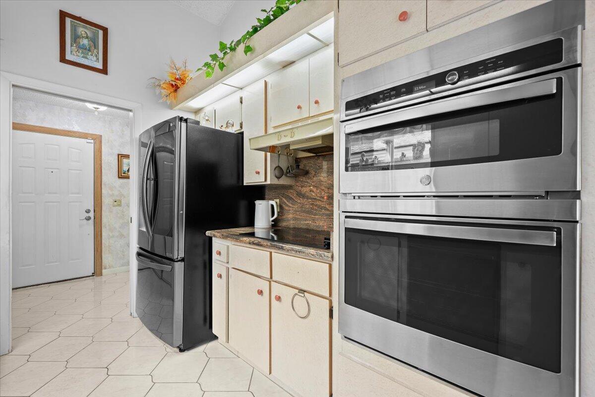 352 River Edge Road Jupiter, FL 33477 - Photo 11 of 56 a kitchen with stainless steel appliances and cabinets