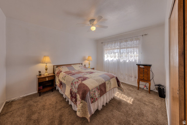 738 Locust Lane Moab, UT 84532 - Photo 9 of 25 Bedroom featuring a ceiling fan and dark carpet