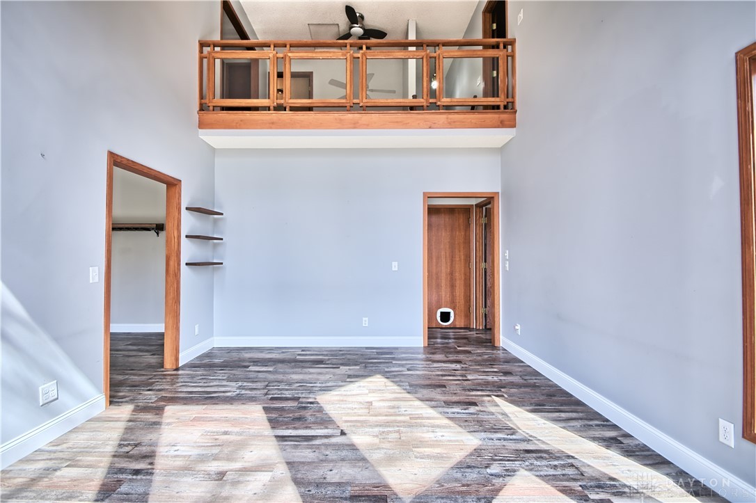8711 Nicole Lane Springboro, OH 45066 - Photo 22 of 87 This living space offers an open concept with a loft overlooking the area, showcasing rich flooring.
