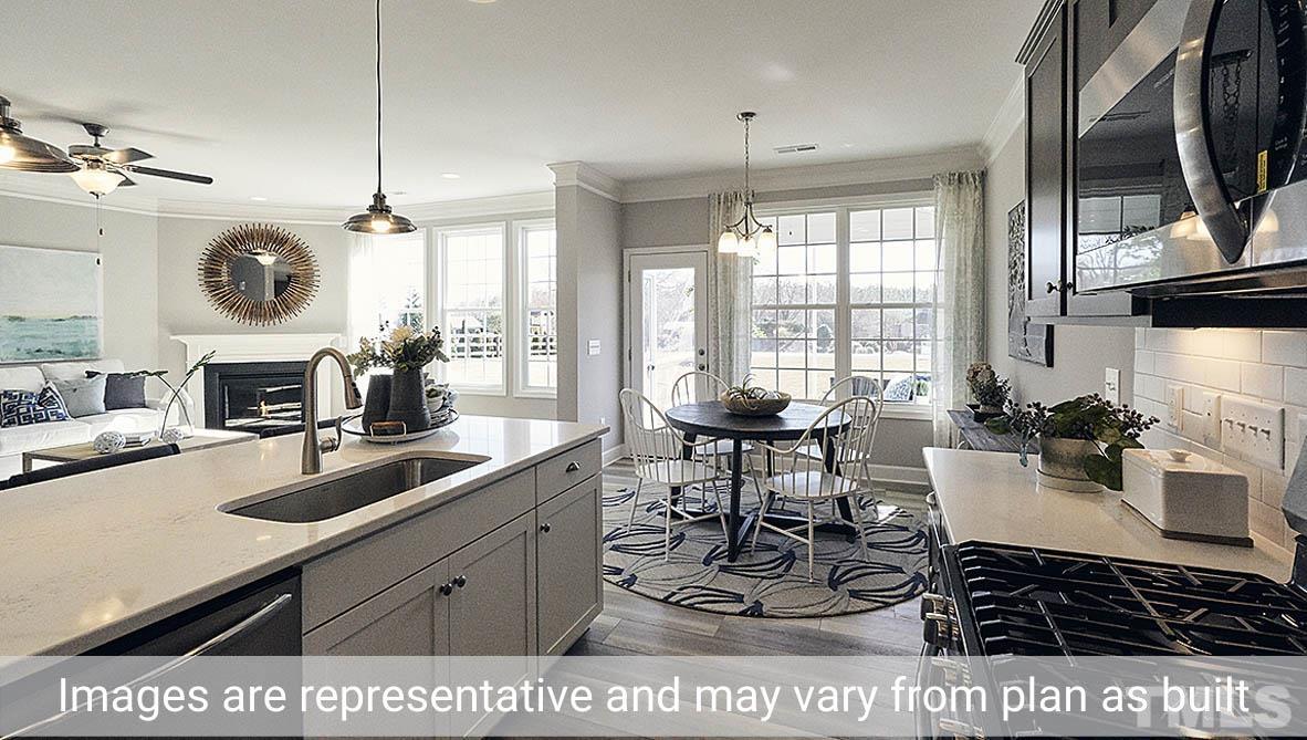 5037 Chase Hill Way Raleigh, NC 27603 - Photo 11 of 41 a kitchen with a sink a stove and a fireplace