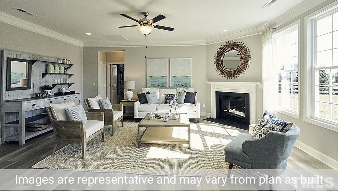 5037 Chase Hill Way Raleigh, NC 27603 - Photo 14 of 41 a living room with furniture a fireplace and a large window