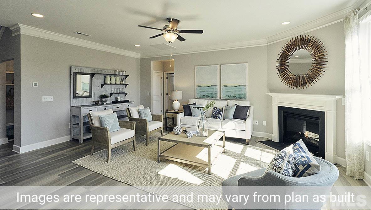 5037 Chase Hill Way Raleigh, NC 27603 - Photo 15 of 41 a living room with furniture a rug and a fireplace