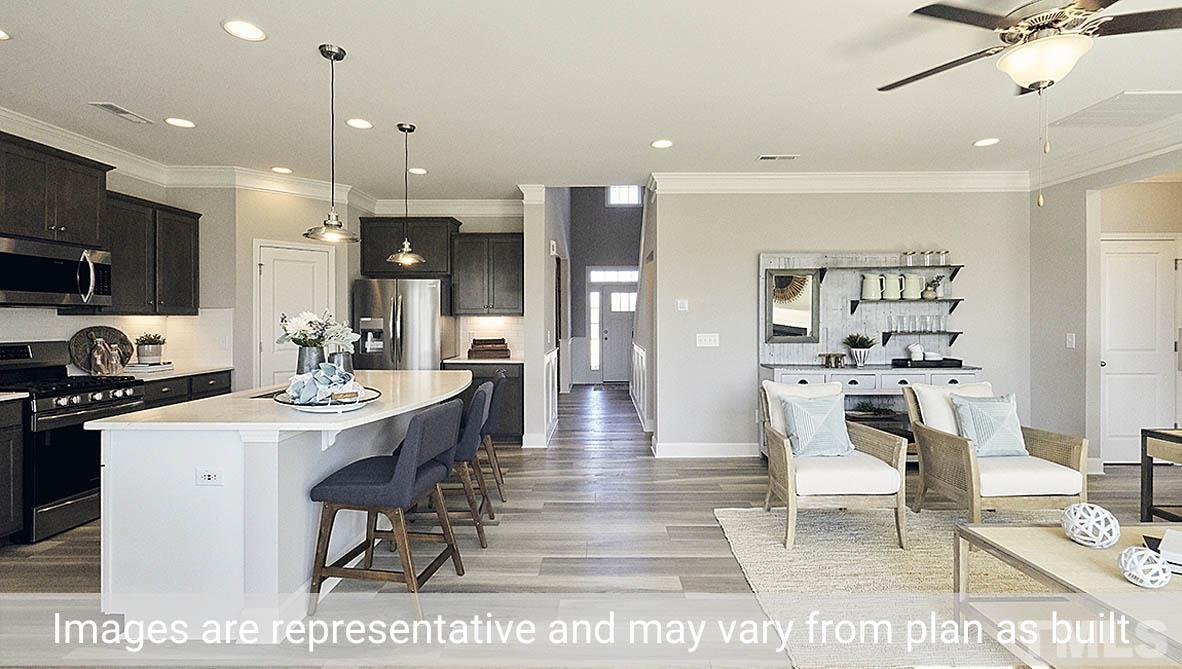5037 Chase Hill Way Raleigh, NC 27603 - Photo 17 of 41 a living room with stainless steel appliances kitchen island granite countertop furniture wooden floor and a view of kitchen