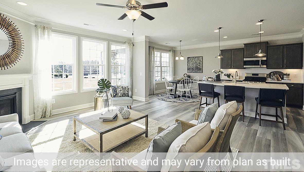 5037 Chase Hill Way Raleigh, NC 27603 - Photo 19 of 41 a living room with furniture dining table and a fireplace
