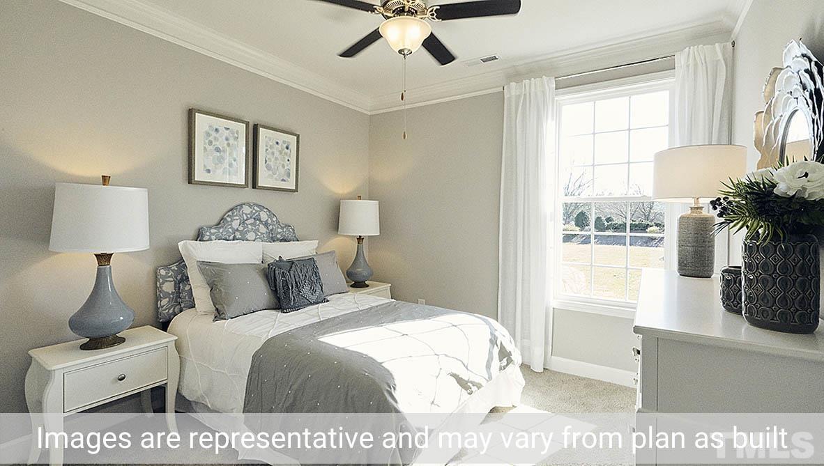 5037 Chase Hill Way Raleigh, NC 27603 - Photo 20 of 41 a bedroom with a bed and a window