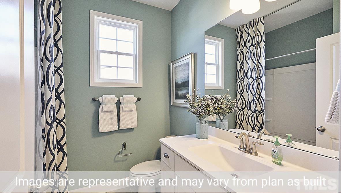 5037 Chase Hill Way Raleigh, NC 27603 - Photo 21 of 41 a bathroom with a sink a toilet and a mirror