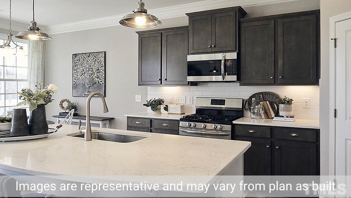5037 Chase Hill Way Raleigh, NC 27603 - Photo 22 of 41 a kitchen with stainless steel appliances a sink a stove a counter space and cabinets