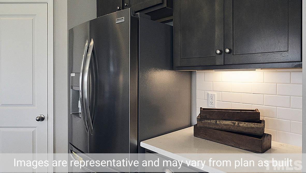 5037 Chase Hill Way Raleigh, NC 27603 - Photo 23 of 41 a kitchen with a refrigerator and cabinets
