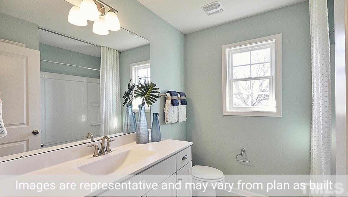 5037 Chase Hill Way Raleigh, NC 27603 - Photo 27 of 41 a bathroom with a sink a mirror and a toilet