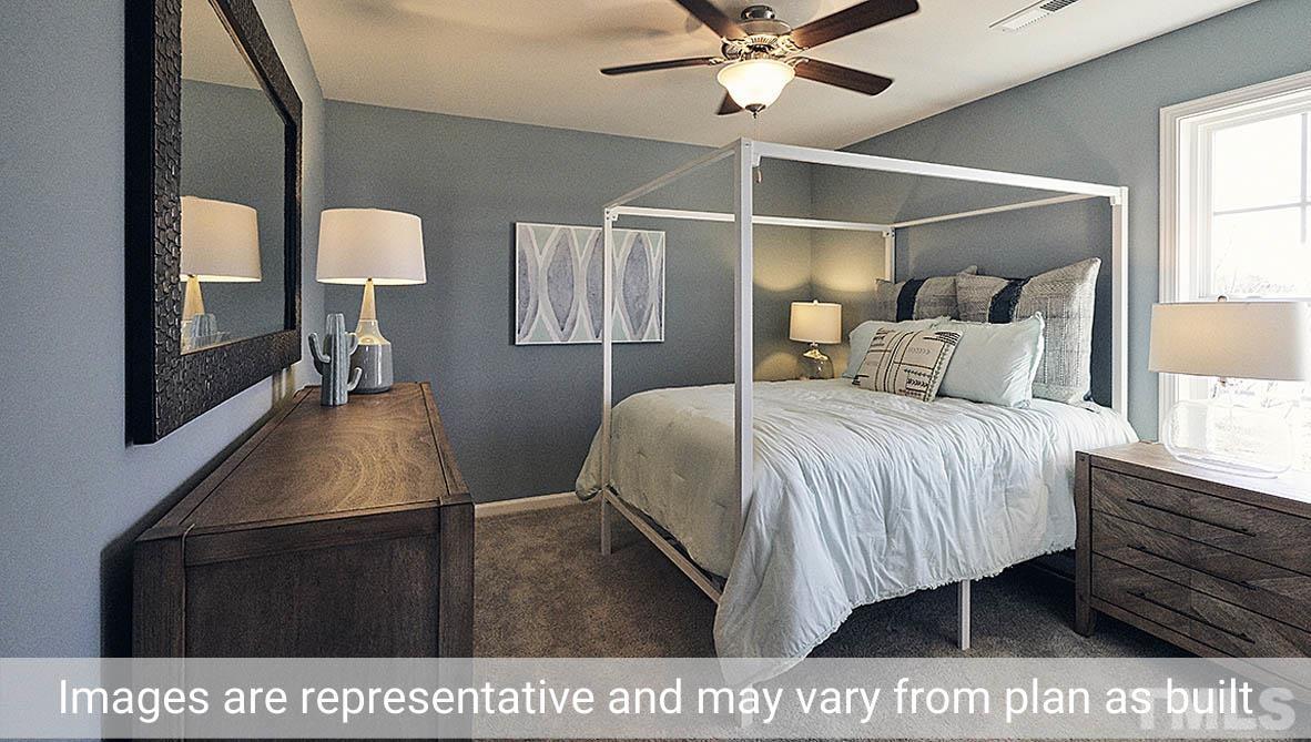 5037 Chase Hill Way Raleigh, NC 27603 - Photo 28 of 41 a bedroom with a bed window and a walk in closet