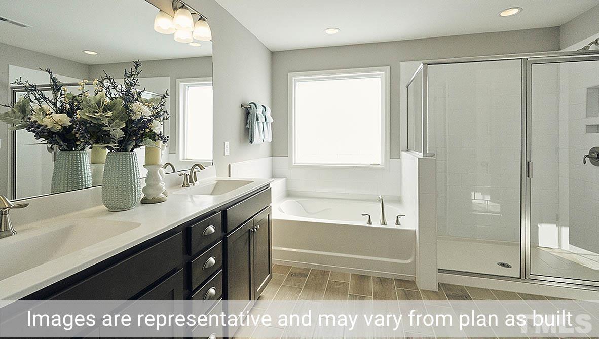 5037 Chase Hill Way Raleigh, NC 27603 - Photo 33 of 41 a bathroom with a sink a mirror and a shower