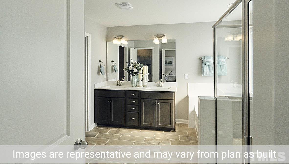 5037 Chase Hill Way Raleigh, NC 27603 - Photo 36 of 41 a bathroom with a sink and a mirror