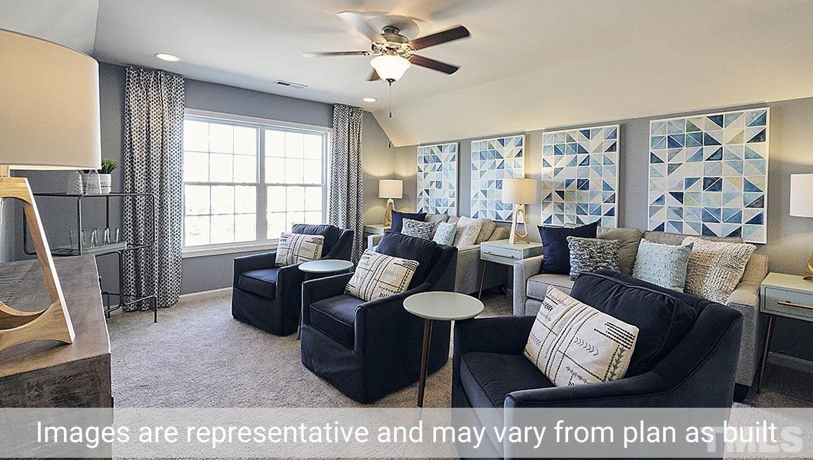 5037 Chase Hill Way Raleigh, NC 27603 - Photo 38 of 41 a living room with furniture a rug and a window