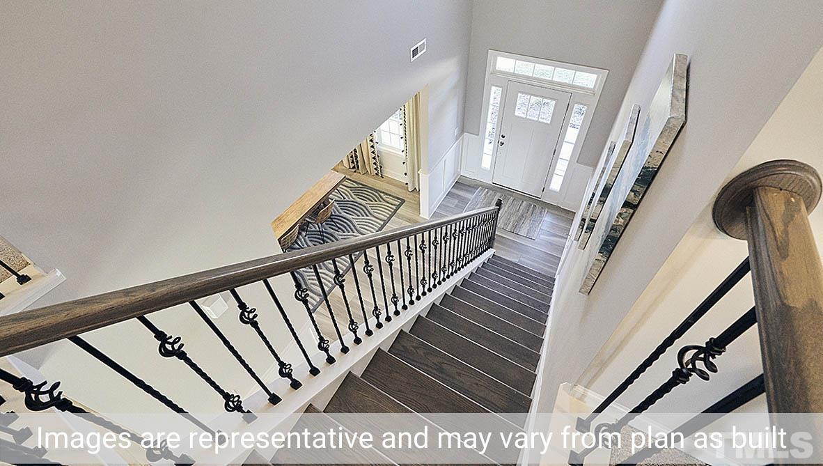 5037 Chase Hill Way Raleigh, NC 27603 - Photo 40 of 41 a view of staircase with railing and wooden floor