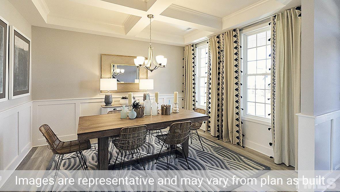 5037 Chase Hill Way Raleigh, NC 27603 - Photo 5 of 41 a view of a dining room with furniture and a chandelier fan