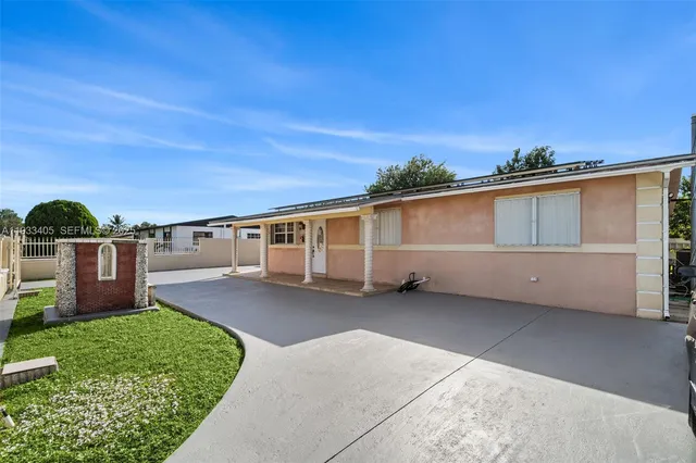 a backyard of a house with table and chairs