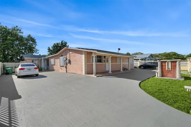 a car parked in front of house with a yard