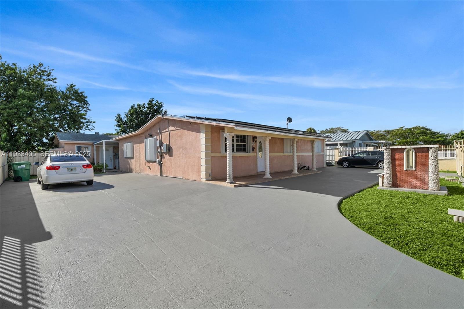 11620 Southwest 179th Terrace Miami, FL 33157 - Photo 2 of 25 a car parked in front of house with a yard