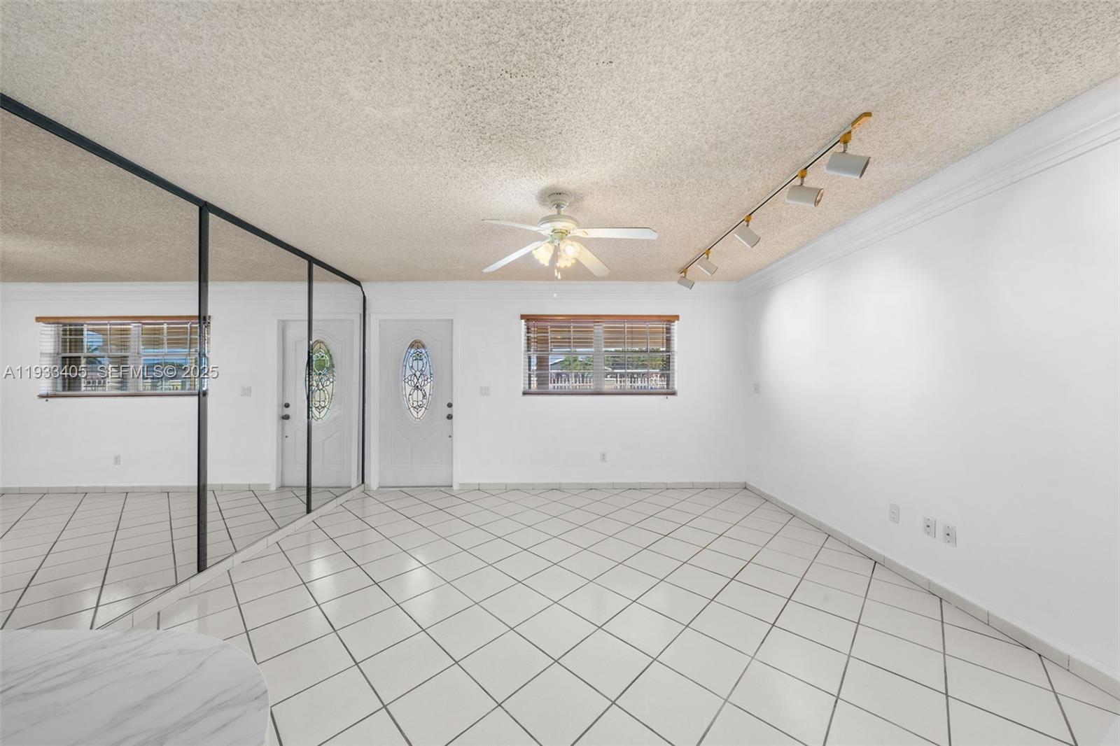 11620 Southwest 179th Terrace Miami, FL 33157 - Photo 3 of 25 an empty room with windows and fan