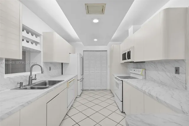 a kitchen with a sink dishwasher and cabinets