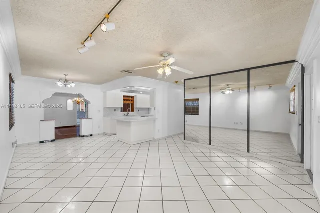 a spacious bathroom with a shower a mirror and a shower