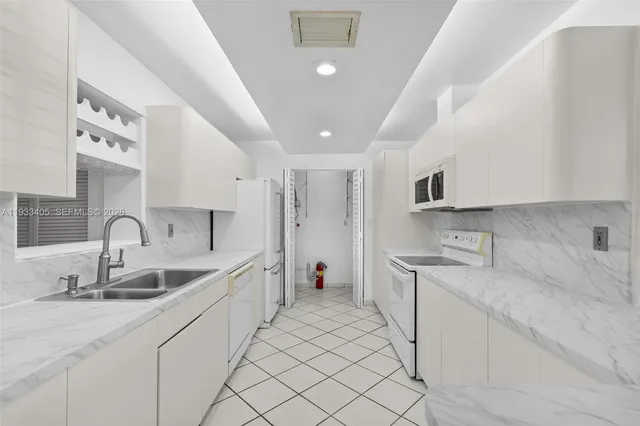 a kitchen with sink stove and cabinets