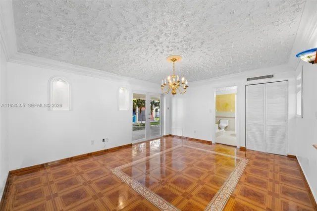 a view of a bedroom with a bed and a chandelier